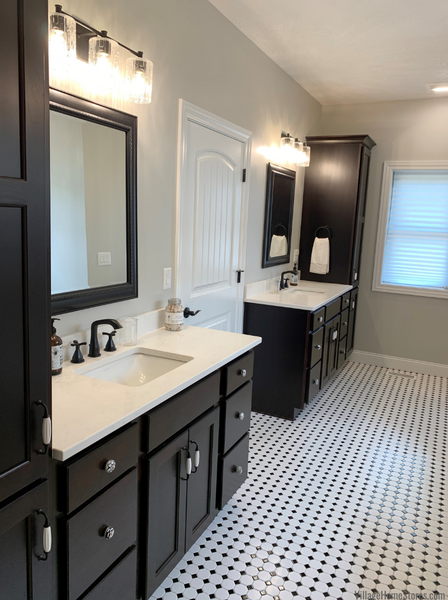 Primary Bathroom With Dark Cabinetry and Classic Black and White Tiles