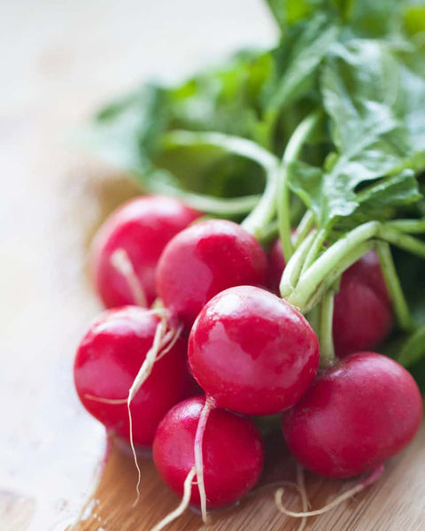 Radishes are a bright pink root vegetable with a crisp, peppery taste. They are commonly enjoyed raw in salads but are great roasted too